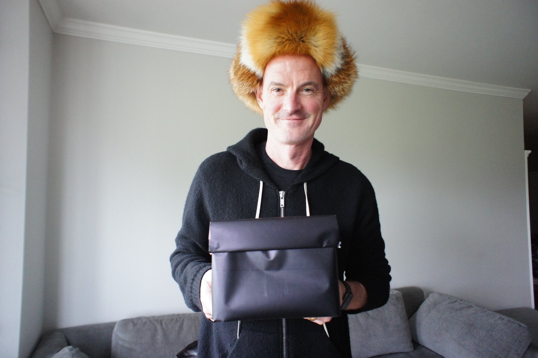 A patron receiving his hat in person